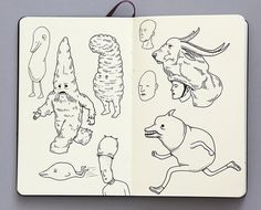 an open notebook with drawings of people and animals