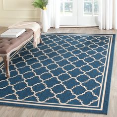 a blue and white rug with a bench in the middle