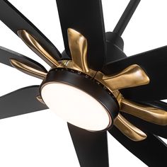 a ceiling fan that is black and gold with a light on the top of it