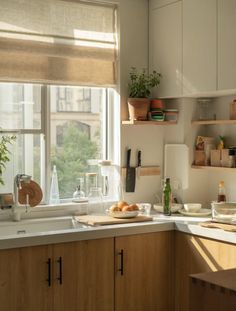 a kitchen filled with lots of counter top space and wooden cabinets next to a window