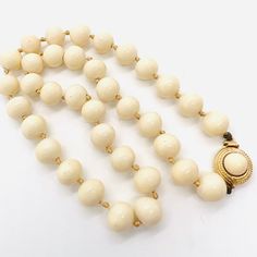 Vintage Signed CINER Cream Off White Colored Glass Beaded Necklace. Ivory colored glass beads,hand knotted on silk with push in gold plated box clasp. In excellent vintage condition with minimal age appropriate wear. Signed on clasp. Beads measure 3/8 inch across and total length is 18 inches. Clasp secure. Beige Beaded Necklace With Gold Round Beads, Vintage Beige Beaded Necklace, Elegant Beige Beaded Necklaces With Large Beads, Elegant Beige Beaded Necklace With Large Beads, Elegant Gold Beaded Necklaces With Wooden Beads, Elegant Cream Necklaces With Large Beads, Elegant Gold Beaded Necklace With Wooden Beads, Vintage White Beaded Necklace With Wooden Beads, Vintage Beige Round Beads Necklace