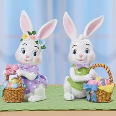 two bunny figurines sitting next to each other