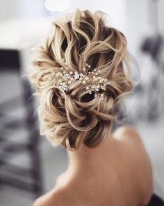 the back of a woman's head wearing a hair comb with pearls on it