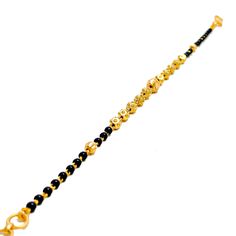 Weighing 4.3 grams, this 22k gold bracelet showcases a graceful yet jazzy design with black bead accents set against a radiant yellow gold finish. The 7.2-inch length, coupled with adjustable 0.6-inch links, ensures a perfect fit for any wrist. Secured by a hook lock, this bracelet offers a beautiful blend of traditional charm and modern flair, making it a versatile piece for both everyday wear and special occasions. PRODUCT DETAILS Gold Purity(karat): 22k Item Weight(grams): 4.3 Item Finish: Ye Festive Yellow Gold Bracelets With Round Beads, Black Bracelets For Festivals, Black Festive Bracelets For Festivals, Black Bangle Bracelets For Festive Occasions, Festive Black Bangle Bracelets, Festive Black Bangle Bracelet, Adjustable 22k Gold Bracelet, Adjustable Yellow Gold Bracelet For Festive Occasions, Traditional Gold Bracelets With Black Beads