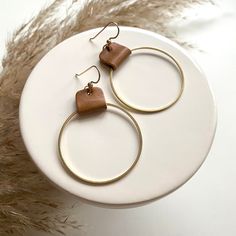 "A circle brass charm hangs from a tan brown leather strap to make the perfect hoop earrings for just about any outfit. They are lightweight on the ears, and a neutral style that will become a favorite go-to pair!  * 2.5\"L x 1.5\" W * 14kt gold filled ear wire. Nickel free * brass circle charm with genuine leather * lightweight More colors available here: https://www.etsy.com/listing/1320410071/leather-and-brass-hoop-earrings-leather ❤️ All of my earrings are packaged with care and attention to Adjustable Brown Hoop Jewelry, Handmade Brown Hoop Earrings For Everyday Wear, Brown Small Hoop Earrings As Gift, Everyday Handmade Brown Hoop Earrings, Brown Brass Dangle Earrings, Brown Hoop Earrings With Ear Wire For Gift, Everyday Brass Circle Earrings, Everyday Brass Circular Earrings, Nickel-free Brown Hoop Jewelry