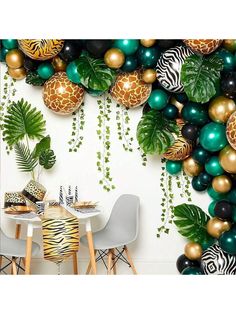 a party scene with balloons, zebras and palm leaves on the wall in front of a jungle theme