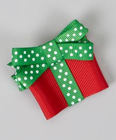 a green and red bow with white polka dots