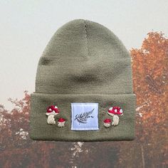 a green hat with red mushrooms on it