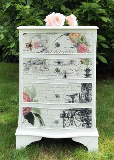 an old dresser with flowers painted on the drawers and some other things sitting on top of it