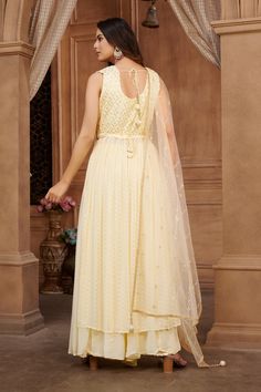 Maitri Georgette Tiki Pearl Embroidered Naira Cut Palazzo Suit. Readymade premium georgette fabric Enhanced with thread & tiki embroidery work Comes with dupatta, palazzo pants Designed with two side slits Comes with waist belt Comes with optional long sleeves fabric. Look your best in this Maitri palazzo suit! Crafted from georgette fabric with pearl embroidery and a Naira cut, this stylish outfit adds sophistication to any wardrobe. The lasting quality of the fabric ensures you'll be wearing t Sleeveless Georgette Salwar Kameez For Reception, Elegant Cutdana Sharara In Maxi Length, Sleeveless Georgette Anarkali Set With Dupatta, Elegant Maxi Length Sharara With Cutdana, Sleeveless Anarkali Set With Dabka Work For Wedding, Sleeveless Georgette Traditional Wear For Eid, Elegant Sleeveless Georgette Anarkali Set, Sleeveless Georgette Salwar Kameez For Navratri, Semi-stitched Sleeveless Georgette Anarkali Set