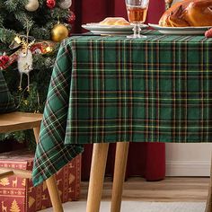 a table topped with a turkey sitting next to a christmas tree