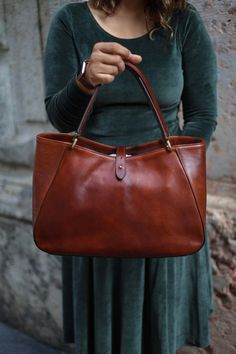 This handmade leather bag is made with 100% natural full grain leather which is tanned with all natural materials. There is no chemical materials in this leather.  This bag is handmade in our studio in Milan.  The lining is 100% cotton and it is easy to clean.  The bag has one middle divider which is a big zipped pocket. There is One smaller zipped pocket in one side and 2 small open pockets  All the bags will come with a cotton dust bag which can protect the leather and bag when it is not in us Elegant Shoulder Bag In Vegetable Tanned Leather, Elegant Vegetable Tanned Leather Shoulder Bag For Everyday Use, Elegant Satchel In Soft Vegetable Tanned Leather, Elegant Top Handle Bag In Vegetable Tanned Leather, Elegant Shoulder Bag In Soft Vegetable-tanned Leather, Elegant Vegetable Tanned Leather Satchel Tote, Elegant Vegetable Tanned Leather Shoulder Bag With Double Handle, Elegant Vegetable Tanned Leather Top Handle Bag, Elegant Vegetable Tanned Leather Bag With Top Handle