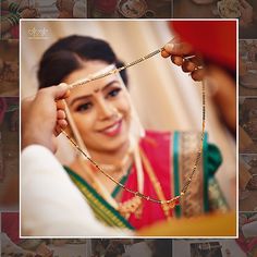 the woman is getting ready to put on her necklace and make it look like she's going to be married