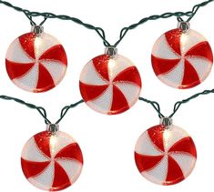 three red and white ornaments hanging from a string