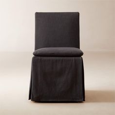 an upholstered chair with a black cover on it