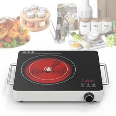 an electric cooktop with various food items in the background