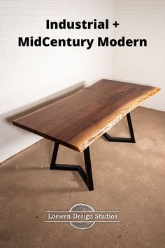 a wooden table sitting on top of a floor next to a white brick wall with the words industrial mid century modern