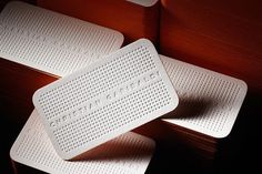 three white placemats sitting on top of each other in front of a black background