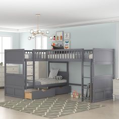 a gray bunk bed sitting in a bedroom next to a dresser and drawers on top of a rug