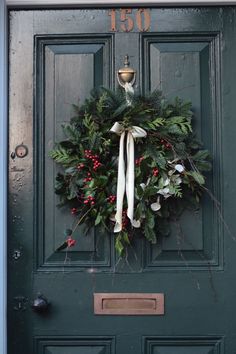 a green door with a wreath on it