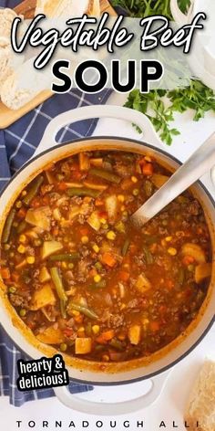 vegetable beef soup in a white bowl with a spoon and bread on the side, next to it