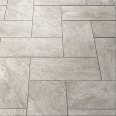 a tile floor that is made out of grey marble tiles and has an irregular pattern