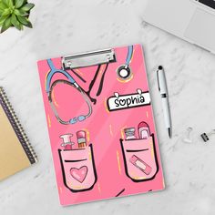 a pink clipboard with doctor's stethoscope on it next to a laptop