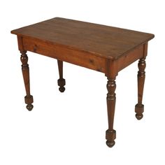 an old wooden table with turned legs