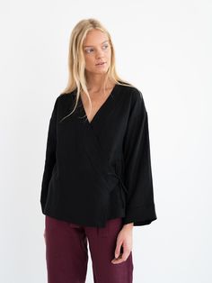 "DELILAH is a linen kimono wrap top. DETAILS - Long wide sleeves - Front side tie closure - 100% lightweight European linen fabric - Cut and sewn to order just for you in our studio COLOR - Black, you can also choose other colors above - Fabric samples are available here https://www.etsy.com/listing/586569696/linen-fabric-samples SIZING & FIT - Relaxed, loose fit - Length is approximately 26.5 inches / 67 cm - Bust is approximately 19 inches / 48 cm - Measurements taken from a size S - Model Layering Wrap Top, Tie Wrap Top, Kimono Wrap Top, Linen Kimono, Kimono Wrap, Linen Clothing, Tie Wrap, Kimono Jacket, Tie Top