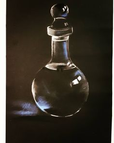 a black and white photo of a glass bottle with a stopper on the top