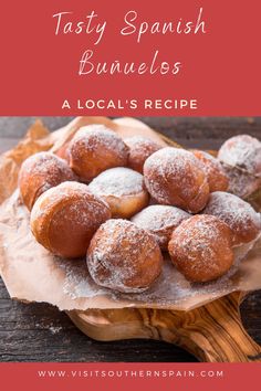 some powdered sugar covered donuts sitting on top of a wooden board with the words tasty spanish bunnies