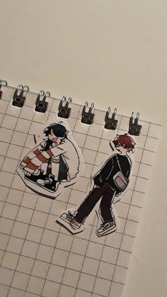 an open notebook with stickers of two people walking on the tile and one person carrying a backpack