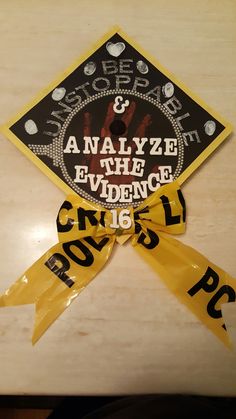 a yellow and black graduation cap with words on it