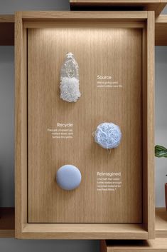 three different types of rocks on display in a wooden case