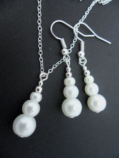 "This is a pretty hand made white glass pearl beads necklace and earring set. Made using 8mm 6mm and 4mm white glass pearl beads. With an 18\" chain. Thanks for looking!!" Gift White Pearl Earrings, Classic White Necklace With Matching Earrings, Gift White Round Pearl Earrings, White Pearl Chain Earrings With Round Beads, Gift White Round Beads Pearl Earrings, White Pearl Dangle Necklace With Pearl Charm, White Beaded Jewelry Sets, White Round Beads Pearl Earrings Gift, Handmade White Pearl Jewelry Sets