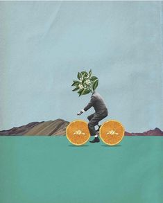 a person riding a bike with two oranges on it