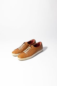 Salvatore Ferragamo cognac leather sneakers. Great condition. Size US 9 As these items are previously owned, we do not accept returns Brown Leather Lace-up Shoes With Perforated Toe Box, Brown Sneakers With Leather Sole And Round Toe, Classic Brown Low-top Custom Sneakers, Custom Casual Brown Sneakers With Plain Toe, Brown Leather Low-top Sneakers, Classic Brown Sneakers With Gum Sole, Brown Calf Leather Sneakers With Contrast Sole, Casual Calf Leather Sneakers With Gum Sole, Casual Brown Custom Sneakers With Rubber Sole