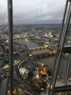 an aerial view of london at night from the top of the shard tower, looking down on the river thames