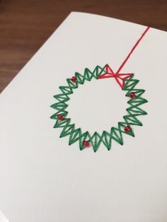 an ornament made out of crochet on top of a white card