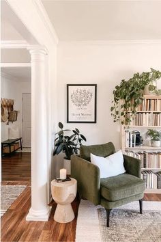 a living room with a green chair and bookshelf in the corner, along with a white rug