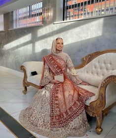 a woman sitting on top of a white couch