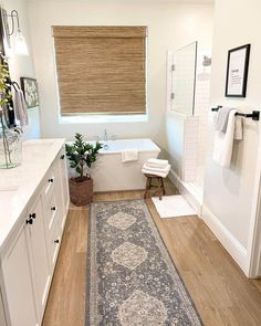 a bathroom with a rug on the floor