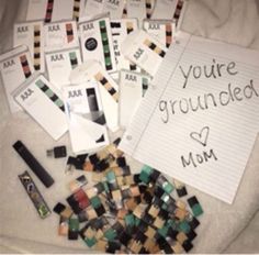 there are many cards and pens on the bed with writing that says, you're grounded mom