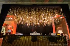 a room filled with lots of lights and chandeliers hanging from the ceiling above it