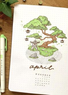 an open notebook with a tree drawn on it and a green pen next to it