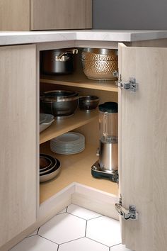 an open cabinet in a kitchen filled with dishes