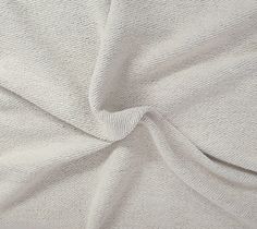 the white fabric is very soft and has been folded up to show it's texture