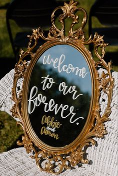 a mirror sitting on top of a table with writing in the frame that says, welcome to our forever