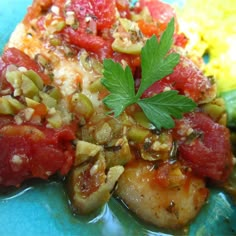 a blue plate topped with meat and vegetables