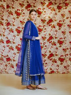 Editor's Note This set features a royal blue embroidered long kurta with dupatta and trouser. Color: Royal Blue Fabric: Silk Chnderi Brocade And Georgette Embroidery Details: Zardozi Care: Dry Clean Only Customize Your Outfit Can't find the size you're looking for? No stress. Just select the size "Custom" while adding the item to your cart. We will follow up with you for your body measurements. To request a color or design customizations, please contact our customer care by using our "Ask us a q Blue Sharara With Straight Kurta For Festive Occasions, Festive Blue Sharara With Straight Kurta, Festive Blue Unstitched Sharara, Traditional Blue Palazzo Set For Festive Occasions, Traditional Blue Palazzo Set For Festive Season, Traditional Drape Blue Embroidered Palazzo Set, Blue Unstitched Sharara For Festive Occasions, Blue Bollywood Palazzo Set With Dupatta, Blue Anarkali Set With Sheer Dupatta For Festive Occasions